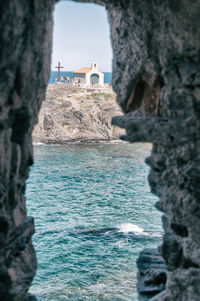 Rock formations by sea against sky