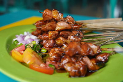 Close-up of served satay in plate