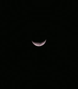 Low angle view of half moon against sky at night