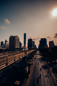 High angle view of street and buildings against sky during sunset