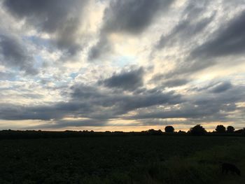 Silhouette of landscape against cloudy sky