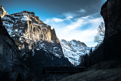 Low angle view of snowcapped mountain against sky