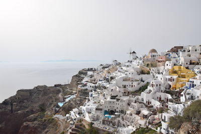 Townscape by sea against clear sky