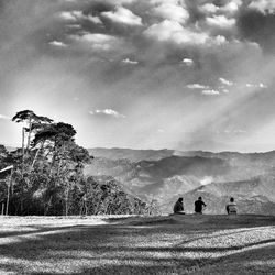Scenic view of mountains against cloudy sky