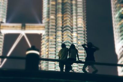 Rear view of man standing on footbridge