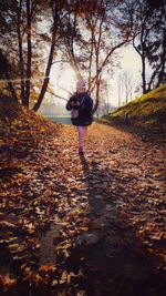 Woman walking on leaves during autumn