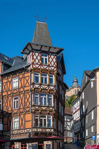 Low angle view of buildings against blue sky