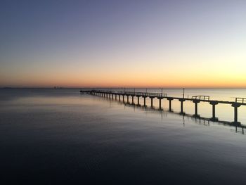 Scenic view of sea against clear sky at sunset