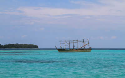 Sailboat in sea against sky