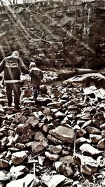 Rear view of people walking on rocks