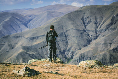 Rear view of man standing on mountain