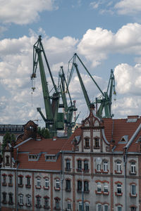 Cranes against buildings in town