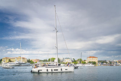 Sailboats in sea against sky