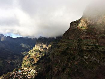 Scenic view of mountain against cloudy sky