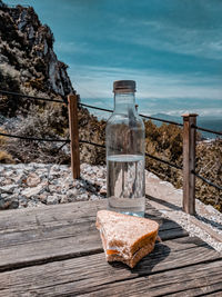 Water bottle and a sandwich for a picnic in overlooking the sea