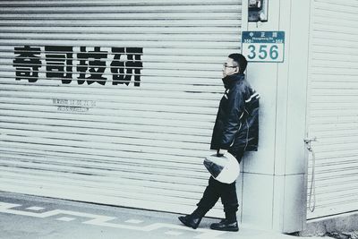 Full length of woman standing by railing