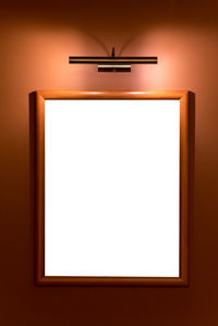 Electric lamp hanging on wall at home