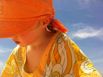 Girl wearing cap against sky