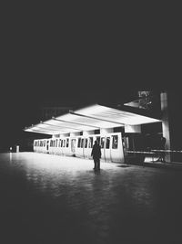 People on illuminated bus at night