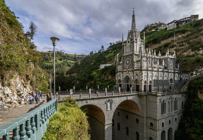 View of arch bridge and building against sky