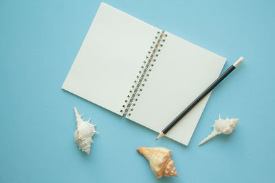 High angle view of pencil on table against blue background