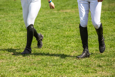 Low section of men standing on field