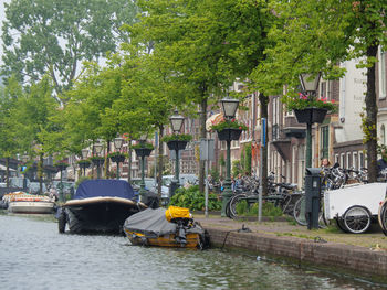 Cars on street by canal in city