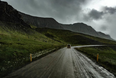 Road amidst mountains against sky