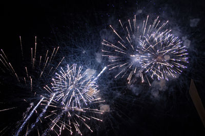 Low angle view of firework display at night