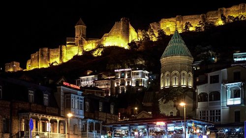 Low angle view of illuminated buildings at night