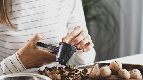 Close-up of woman holding food on table