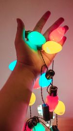 Close-up of hand holding balloons