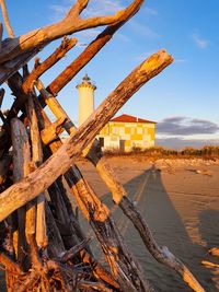 Abandoned built structure on beach against sky