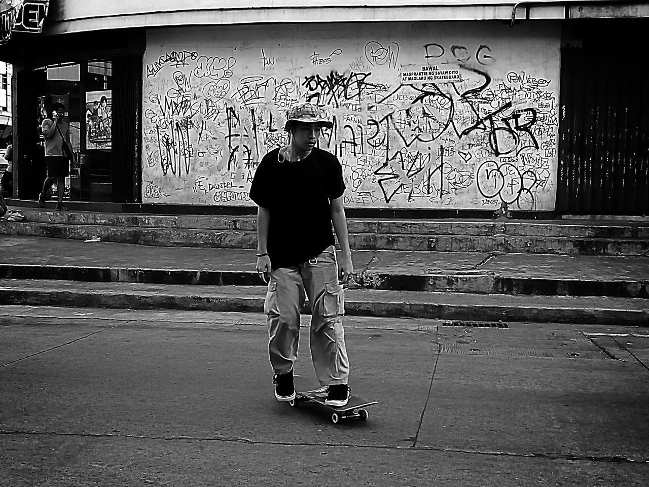 FULL LENGTH OF MAN STANDING ON COBBLESTONE