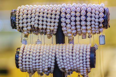 Close-up of pearl jewelry on rack in store