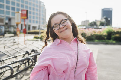 Smiling teenage girl with down syndrome wearing eyeglasses