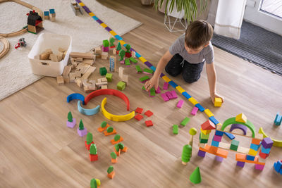 High angle view of siblings playing with toys on table