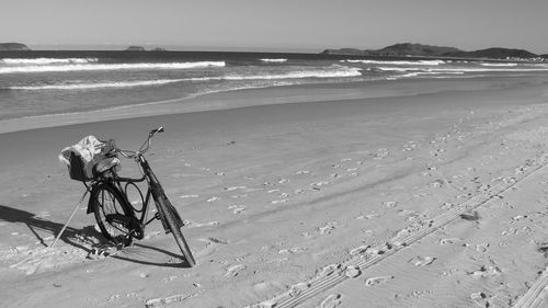 Bicycle parked at sandy beach