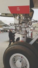 Low section of man on airplane at airport