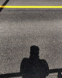 Shadow of person on road