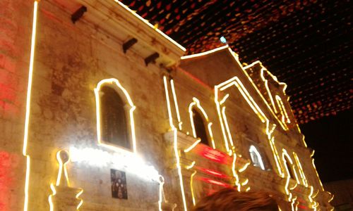 Low angle view of illuminated building at night