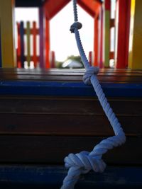 Close-up of rope tied on wood