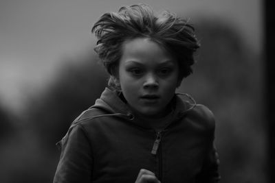 Portrait of young woman standing outdoors