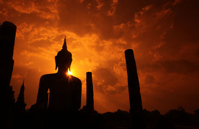 Low angle view of silhouette statue against sky during sunset