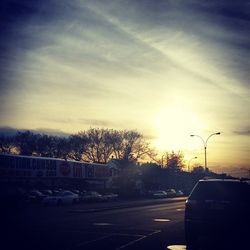 Cars on road at sunset