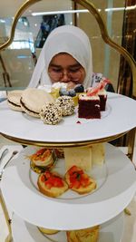 Portrait of woman with ice cream in restaurant