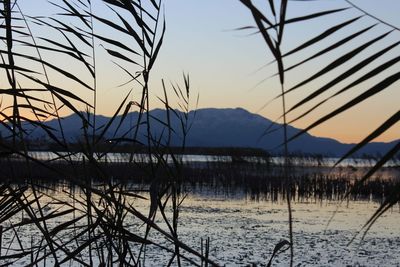 Scenic view of lake against sky during sunset