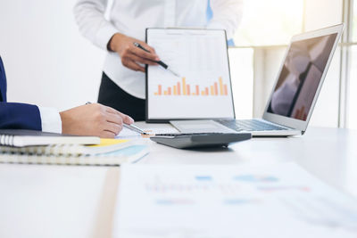 Close-up of business colleagues working in office