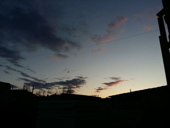 Low angle view of silhouette buildings against sky during sunset