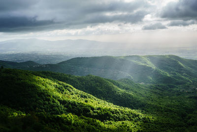 Scenic view of mountains against cloudy sky